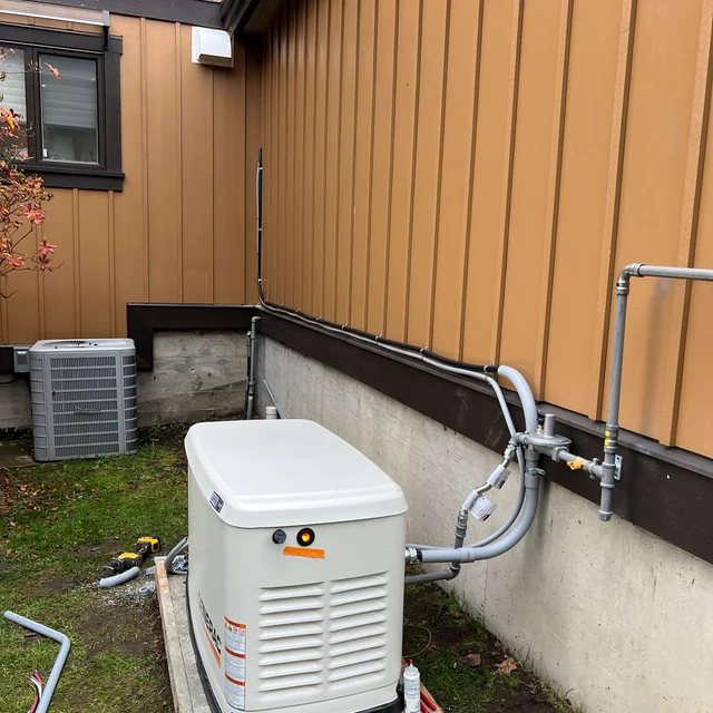 Outdoor standby generator beside the Belcarra home